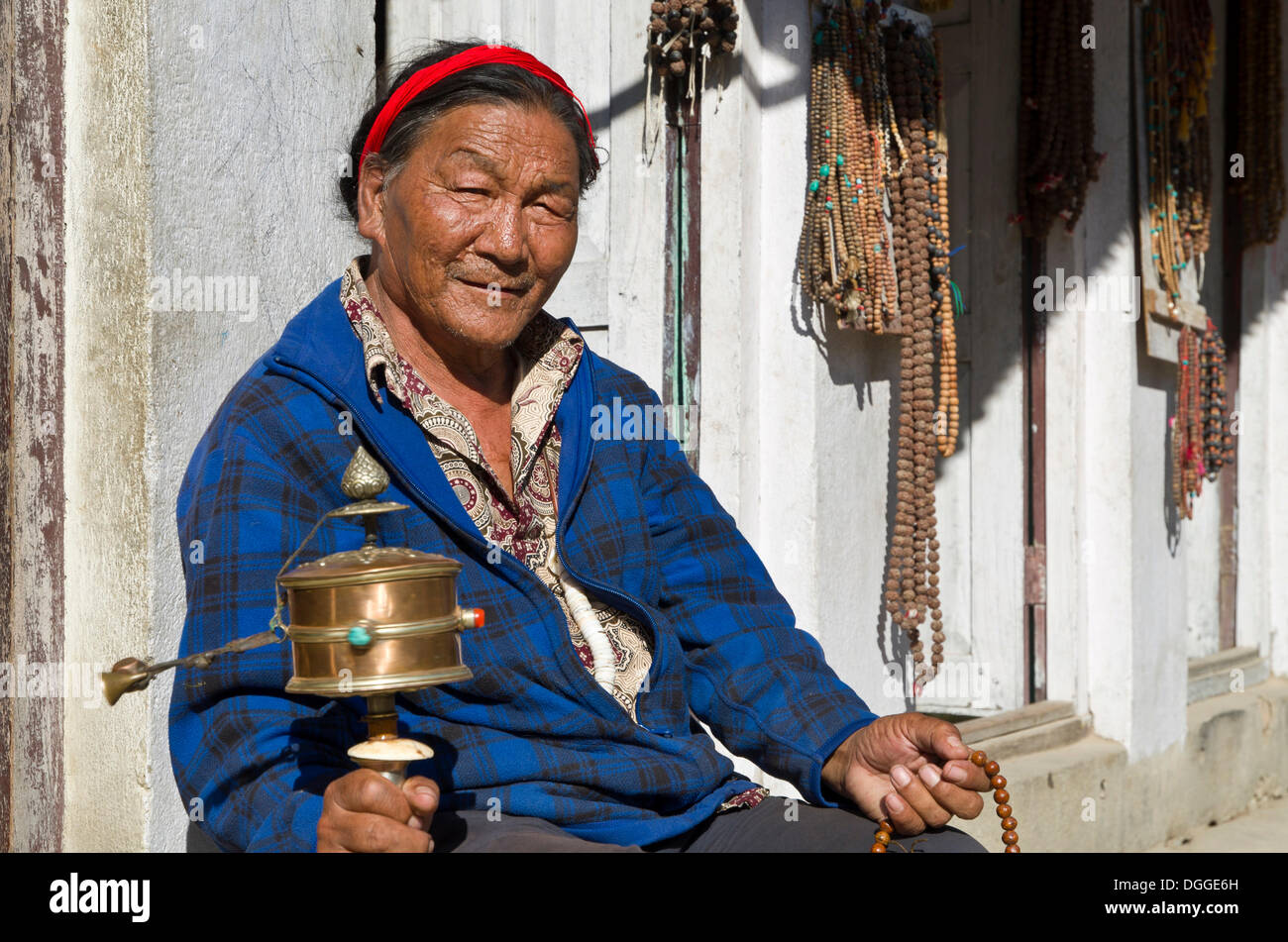 Tibetan pilgrim turning a prayer mill, Kathmandu, Kathmandu District, Bagmati Zone, Nepal Stock Photo