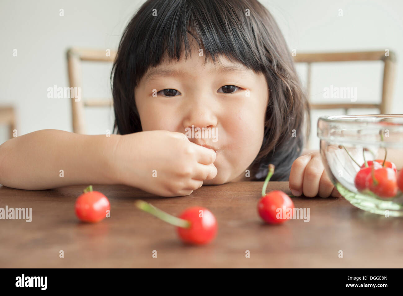 Girl eating cherries, portrait Stock Photo