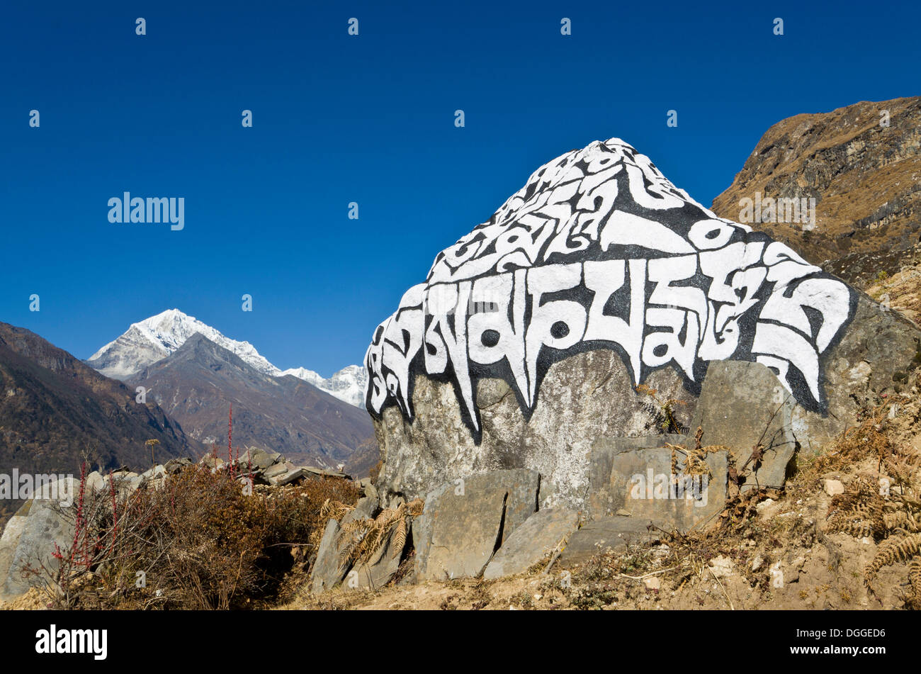 Big Mani Stone in the valley above Namche Bazar (3.440 m), the base for trekking and mountaineering in Solo Khumbu region Stock Photo
