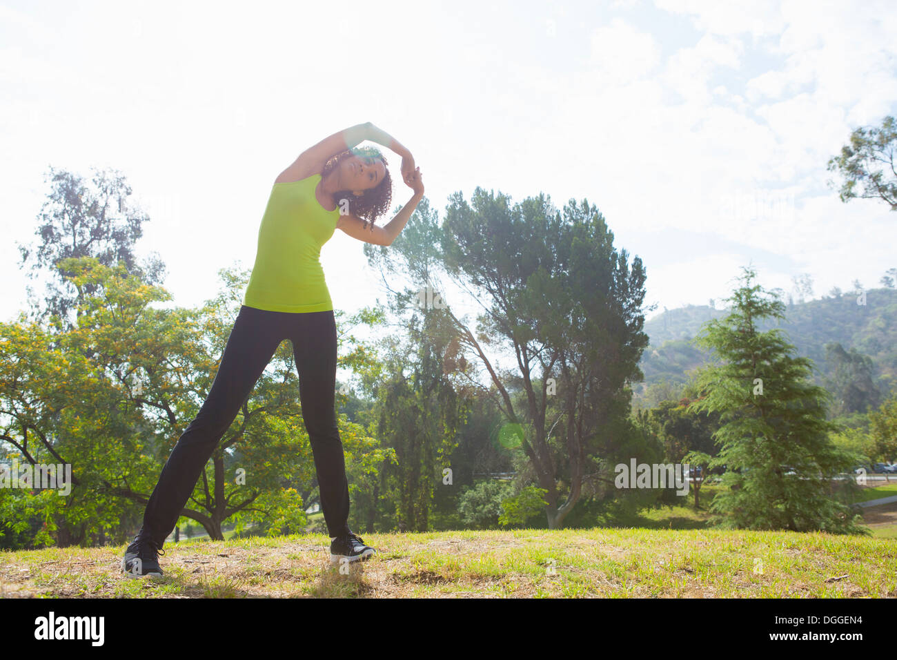 Mid adult woman stretching hi-res stock photography and images - Alamy