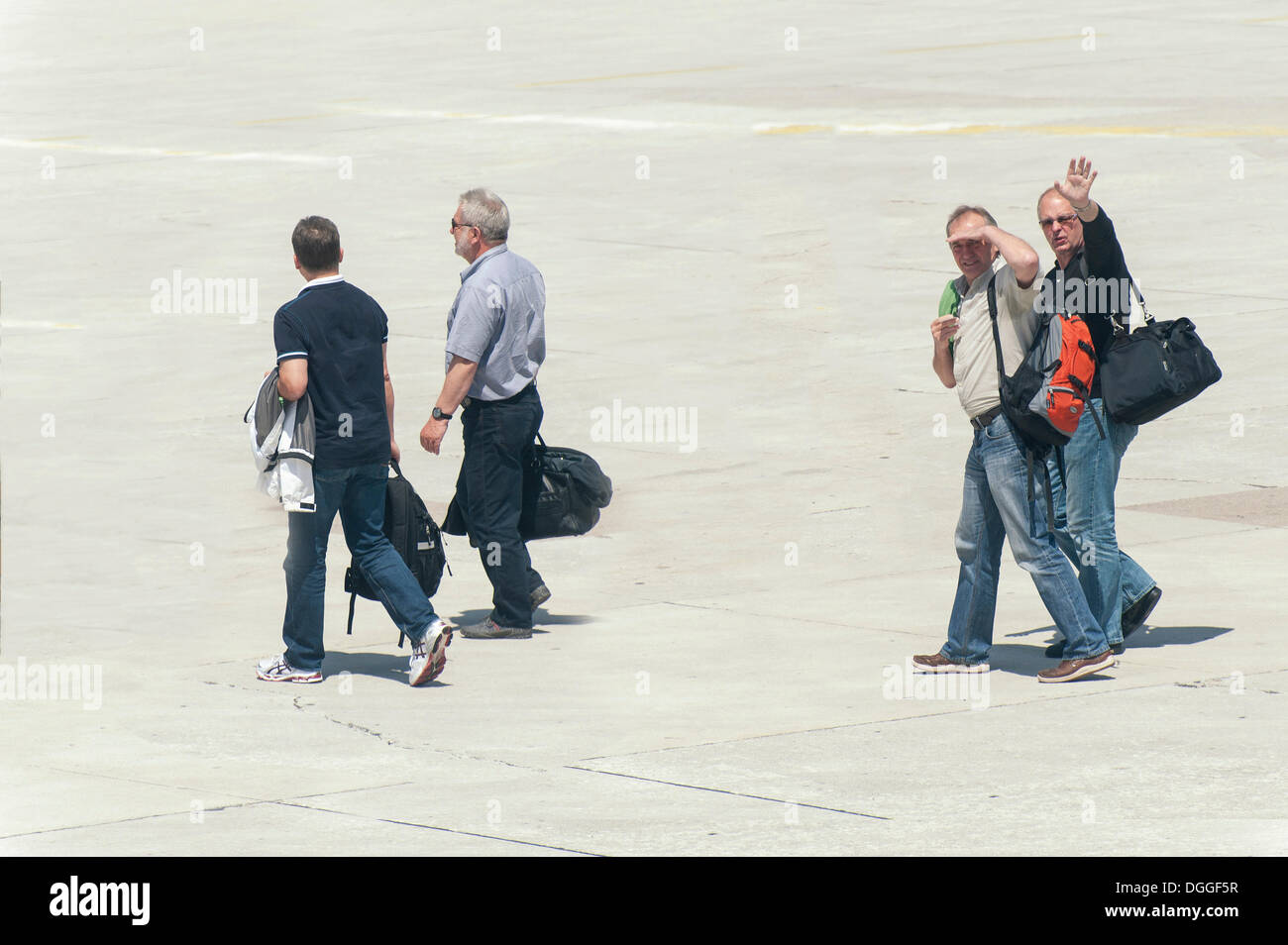 Four people walking across the tarmac to their plane, Split, Croatia, Europe Stock Photo