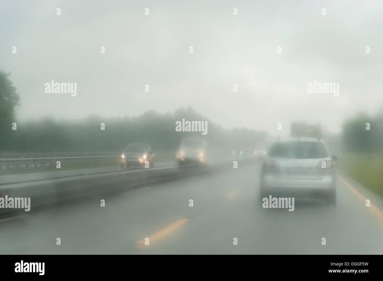 View through the windshield of a car driving on a highway in the rain, Lower Saxony Stock Photo
