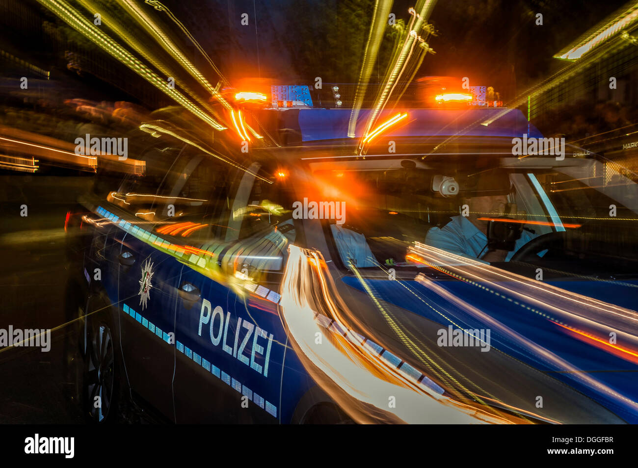 Night shot of a moving police car, Duesseldorf, North Rhine-Westphalia Stock Photo