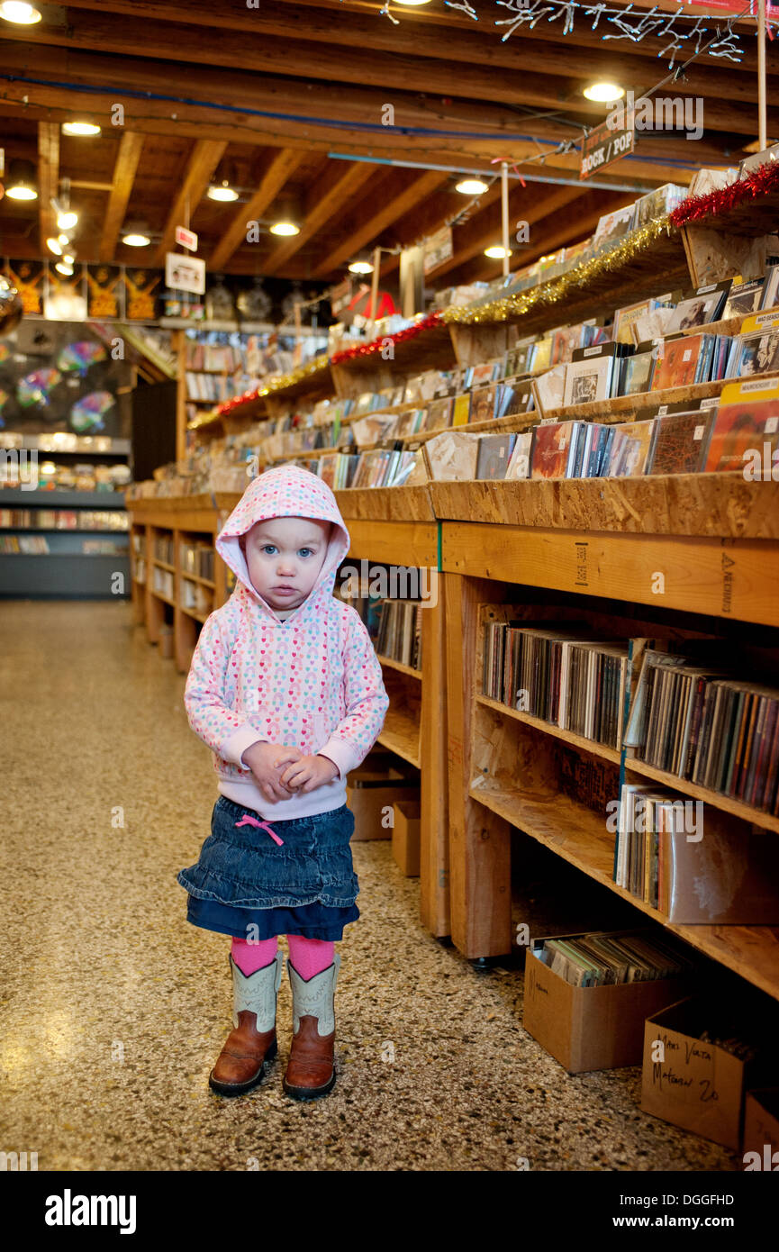 Young girl standing in store, portrait Stock Photo - Alamy