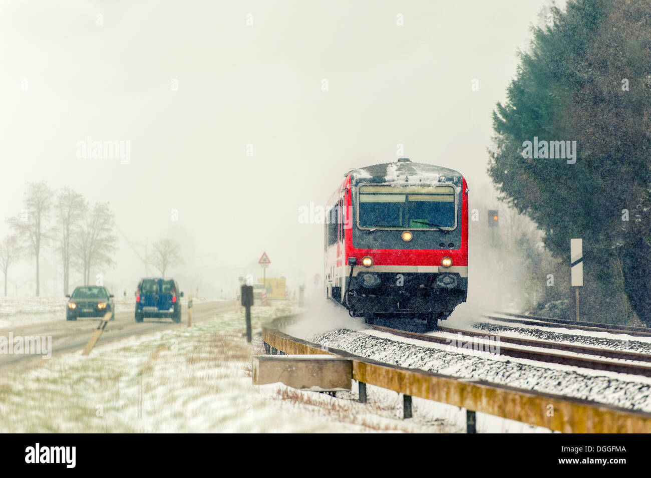 Road and rail transport in winter with snow, Grevenbroich, Rhineland, North Rhine-Westphalia, Germany Stock Photo