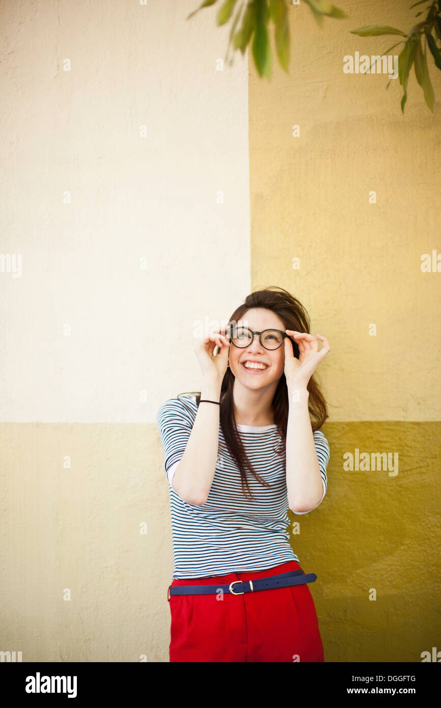 Portrait of young woman in front of color divided wall Stock Photo - Alamy