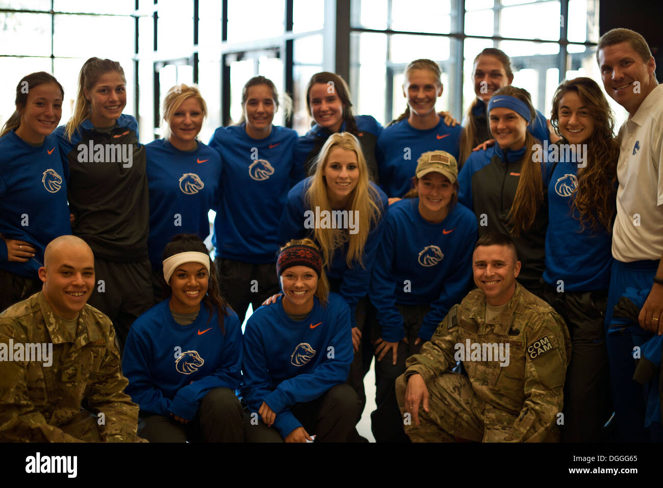 The Boise State University ladies soccer team and Ed Moore, Broncos assistant coach (white shirt) met with Air Force Master Sgt. Kevin Wallace (front-right) and Airman 1st Class Devin Nothstine at Mountain Home Air Force Base, Idaho, Oct. 5, 2013. Wallace Stock Photo