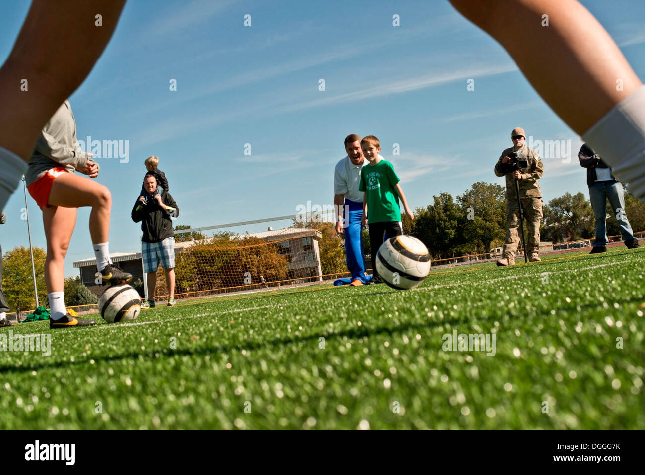 Nine-year-old Cyrus Carlsness, son of Tech. Sgt. Tim Carlsness, 366th Operations Support Squadron, shoots a ball between the le Stock Photo