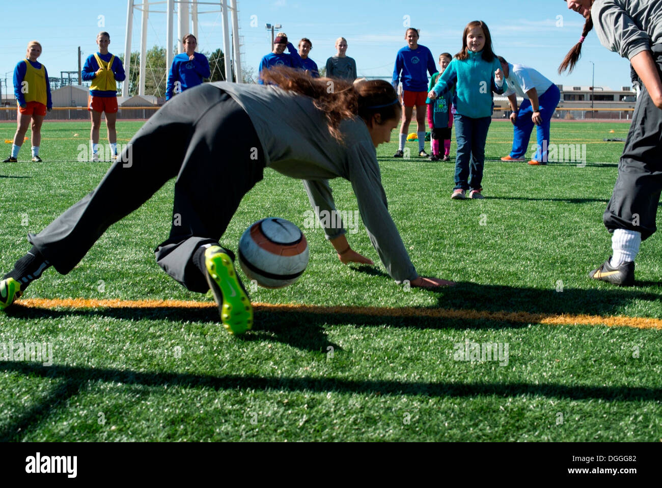 Eight-year-old Natalie Carlsness, daughter of Tech. Sgt. Tim Carlsness, 366th Operations Support Squadron, takes a shot at goal Stock Photo