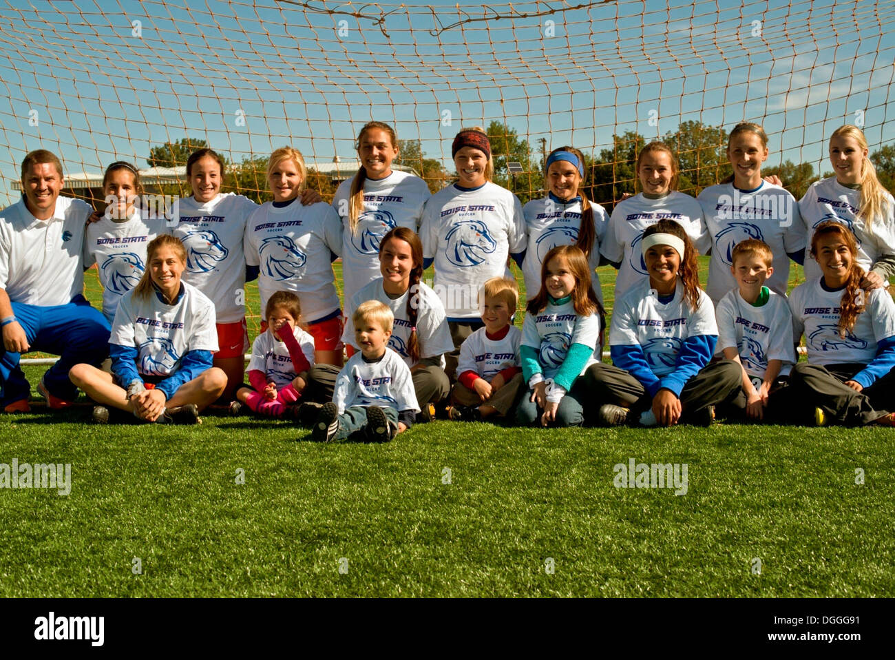 The Boise State University ladies soccer team and Ed Moore, Broncos assistant coach (left) met with Air Force Wounded Warriors and hosted a free soccer clinic for family members at Mountain Home Air Force Base, Idaho, Oct. 5, 2013. The BSU Broncos in atte Stock Photo