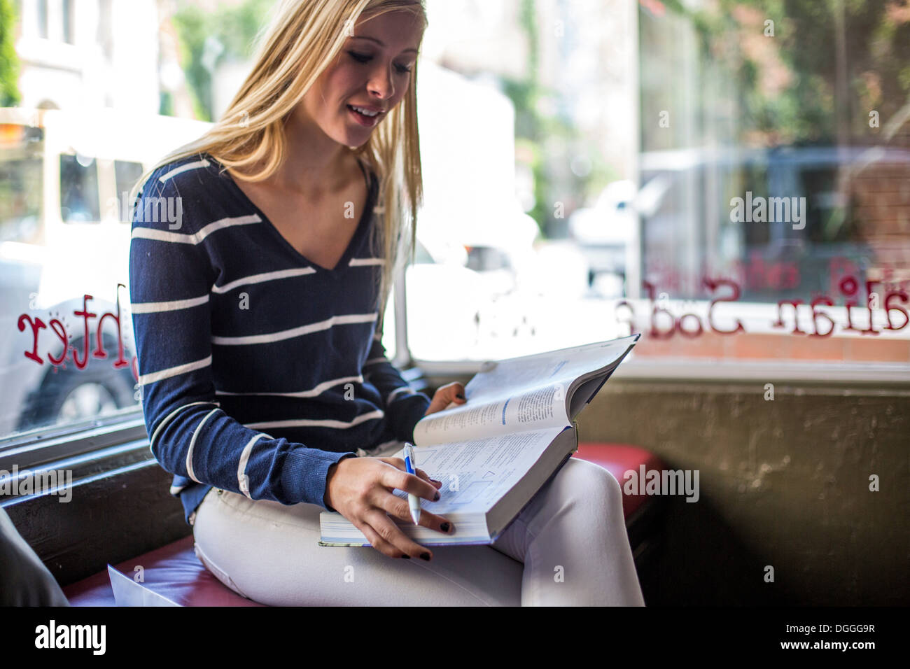 Teenage girl studying in cafe Stock Photo - Alamy