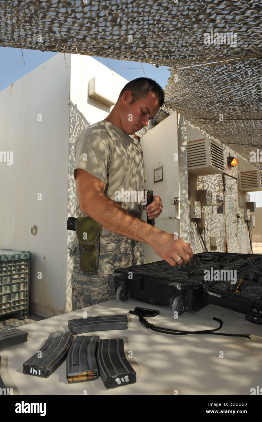 Senior Airman Matthew Coffman loads ammunition into magazines at the 379th Air Expeditionary Wing in Southwest Asia, Oct. 7, 2013. The Expeditionary Theater Distribution Center transient armory stores weapons for transient personnel. Coffman is a 379th Ex Stock Photo