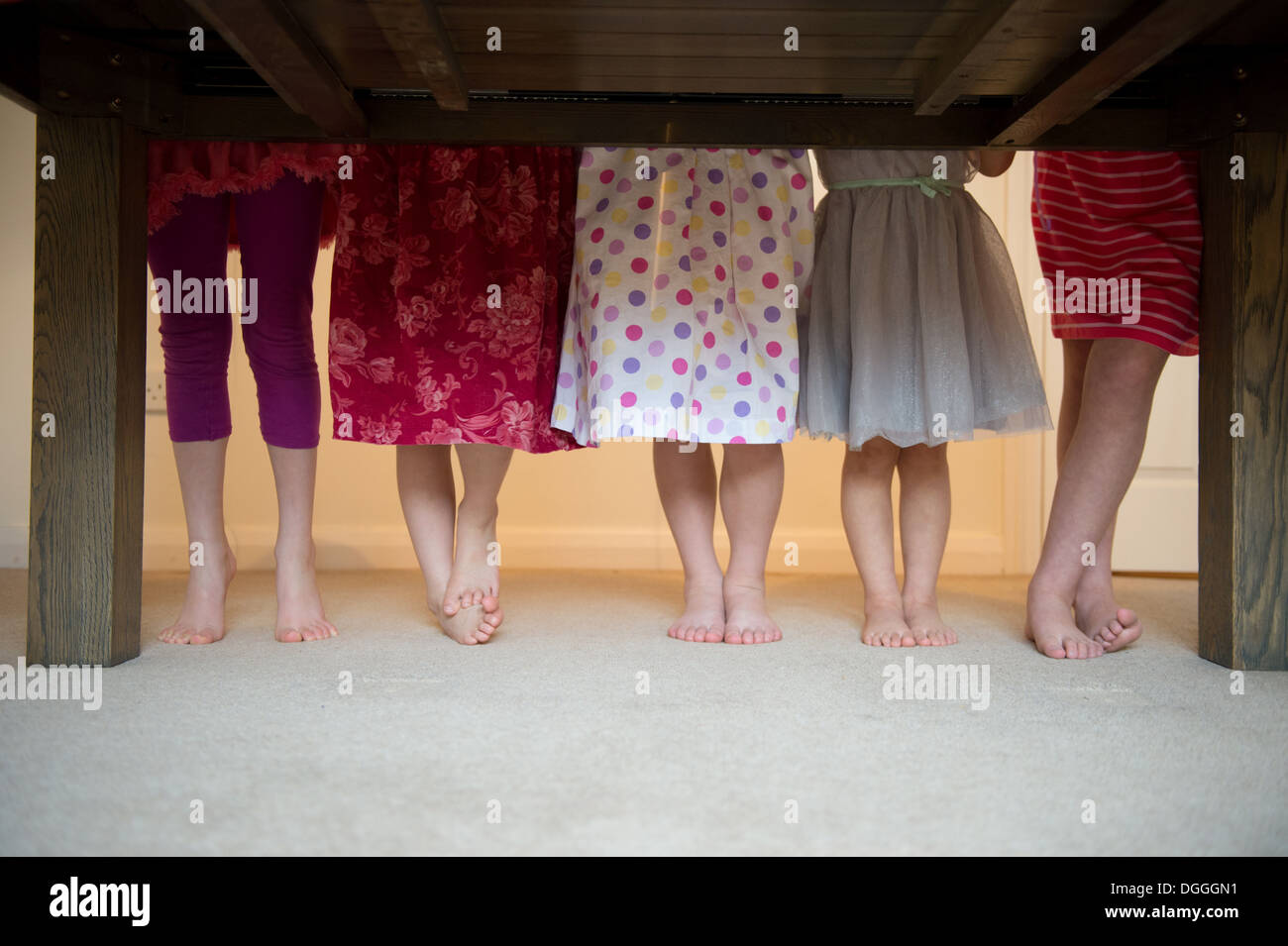 Girls standing together with barefeet in a row, low section Stock Photo