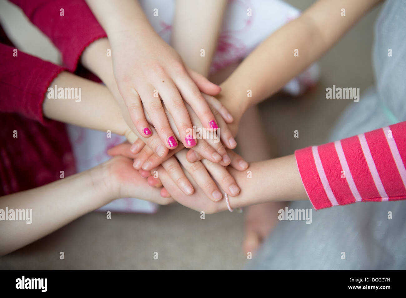 Girls putting hands together, close up Stock Photo