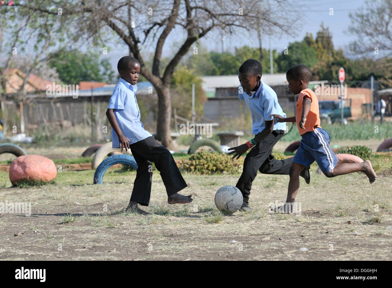Three boys playing football, Cape Town, South Africa, Africa Stock Photo