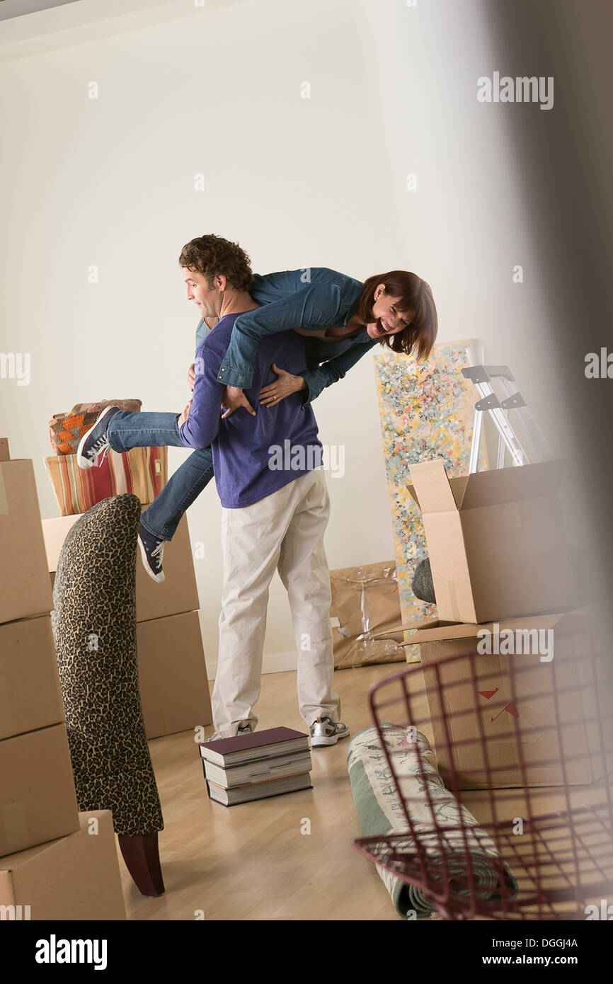 Couple having fooling about whilst moving Stock Photo