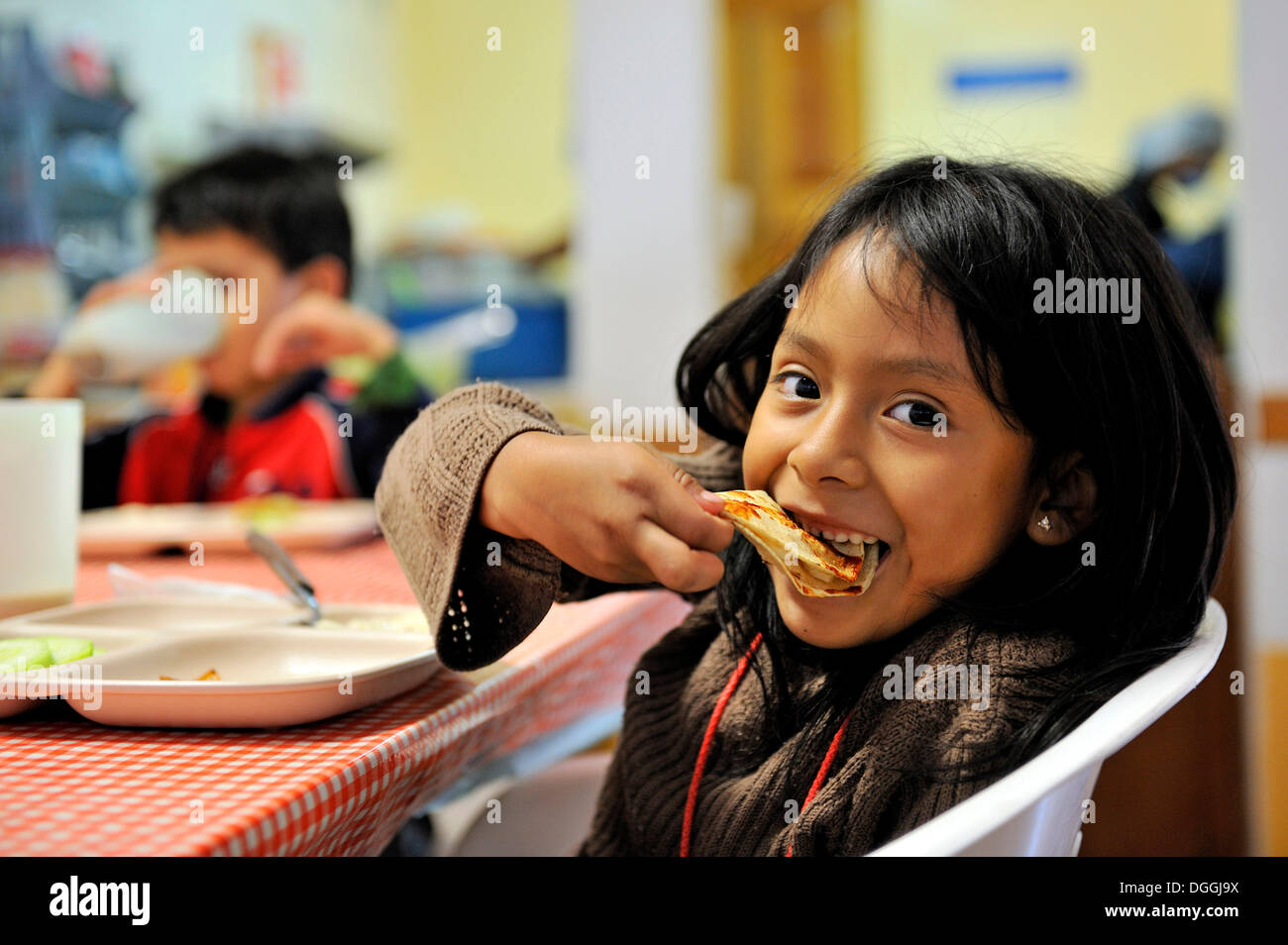 Girl eating a tortilla, Puebla, Mexico, Central America Stock Photo