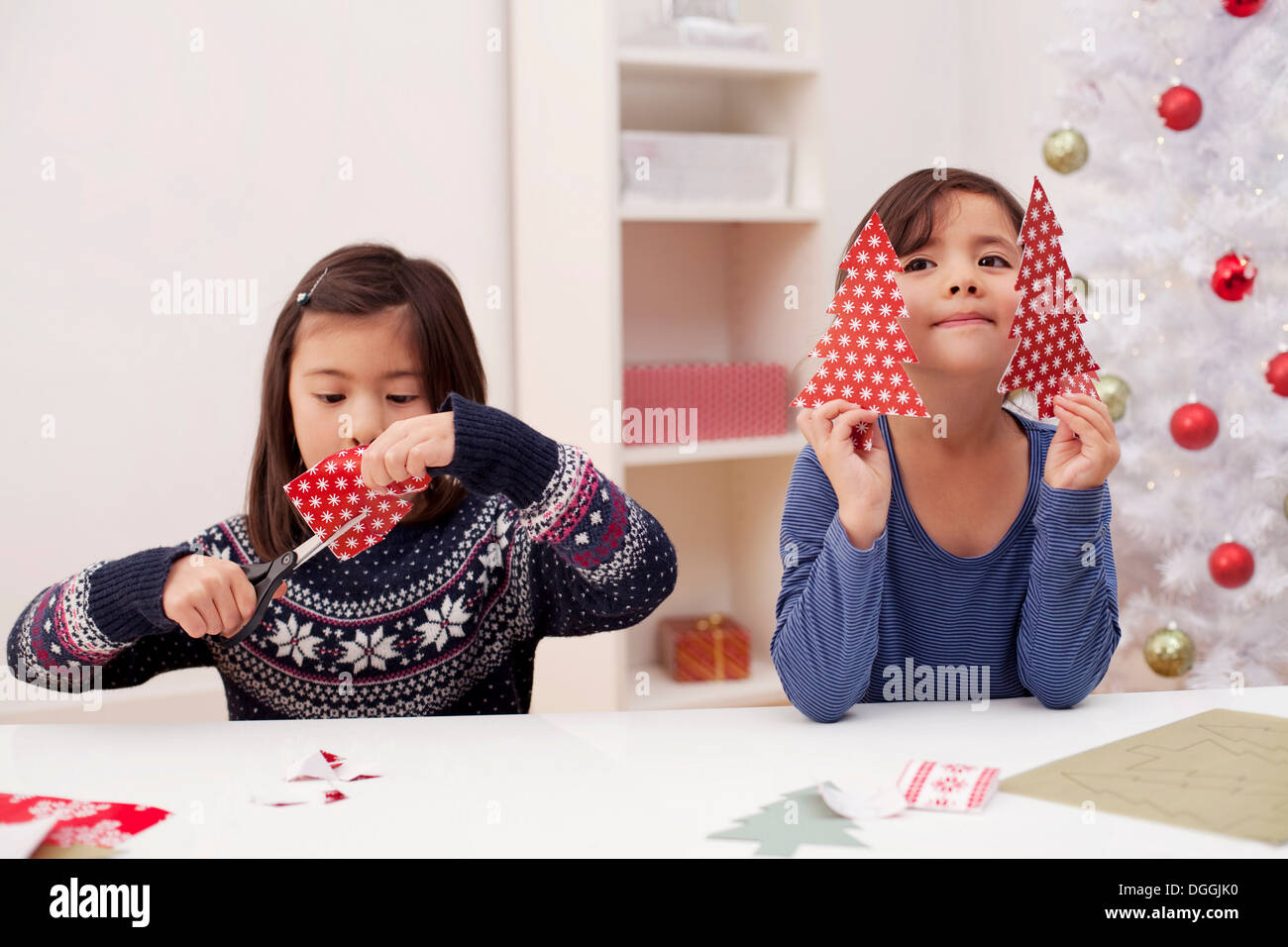 Girls holding and making Christmas decorations Stock Photo