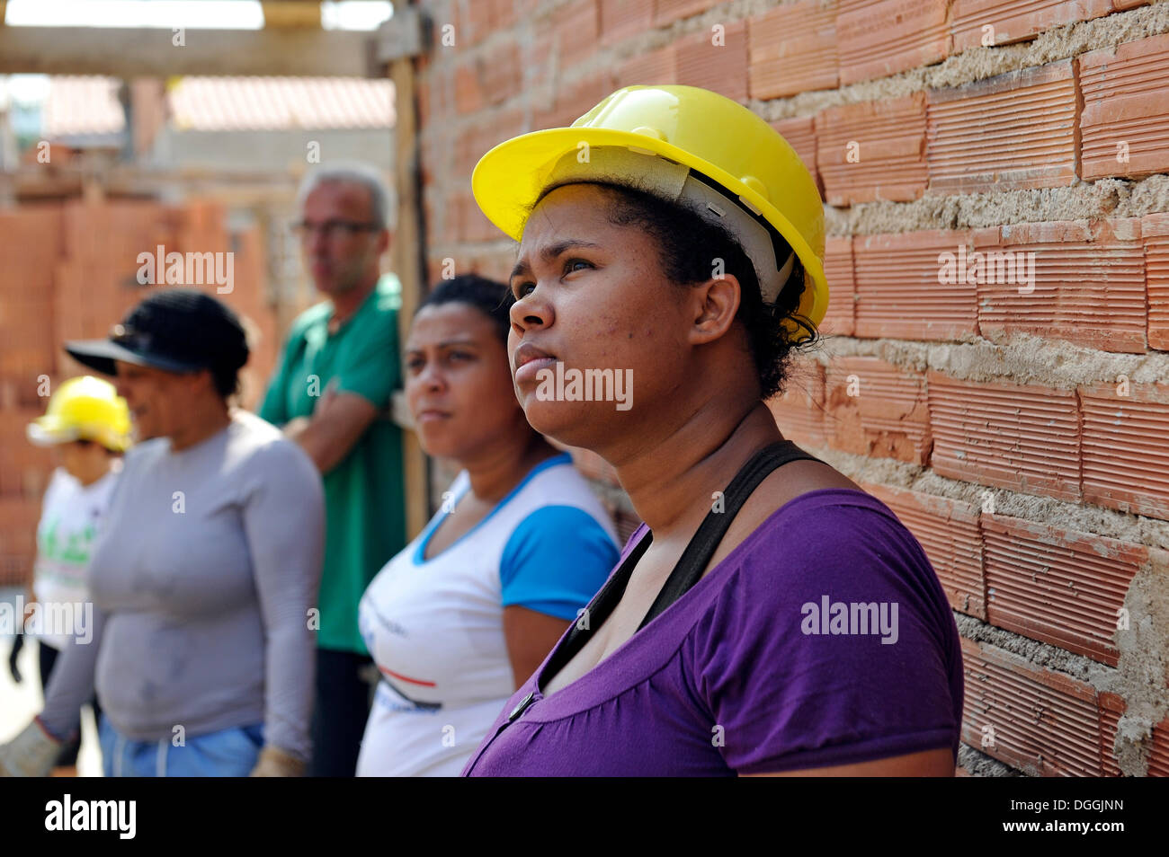 Young woman from the slums, favelas, on a building site of the "Esperanca" housing co-operative, each family helping out on the Stock Photo