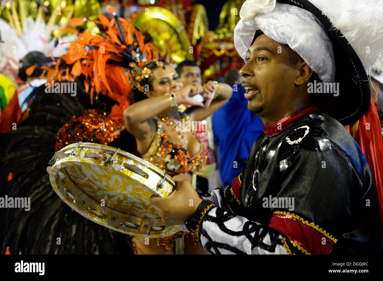 Musician of the drum group Bateria with pandeiro, parade of the samba school Inocentes de Belford Rocho, Sambodromo Stock Photo
