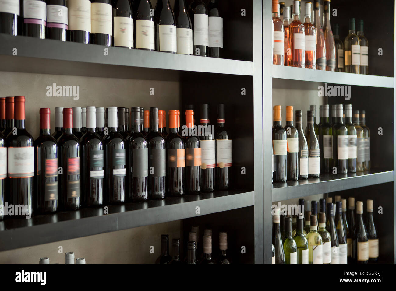 Wine bottles on shelves Stock Photo