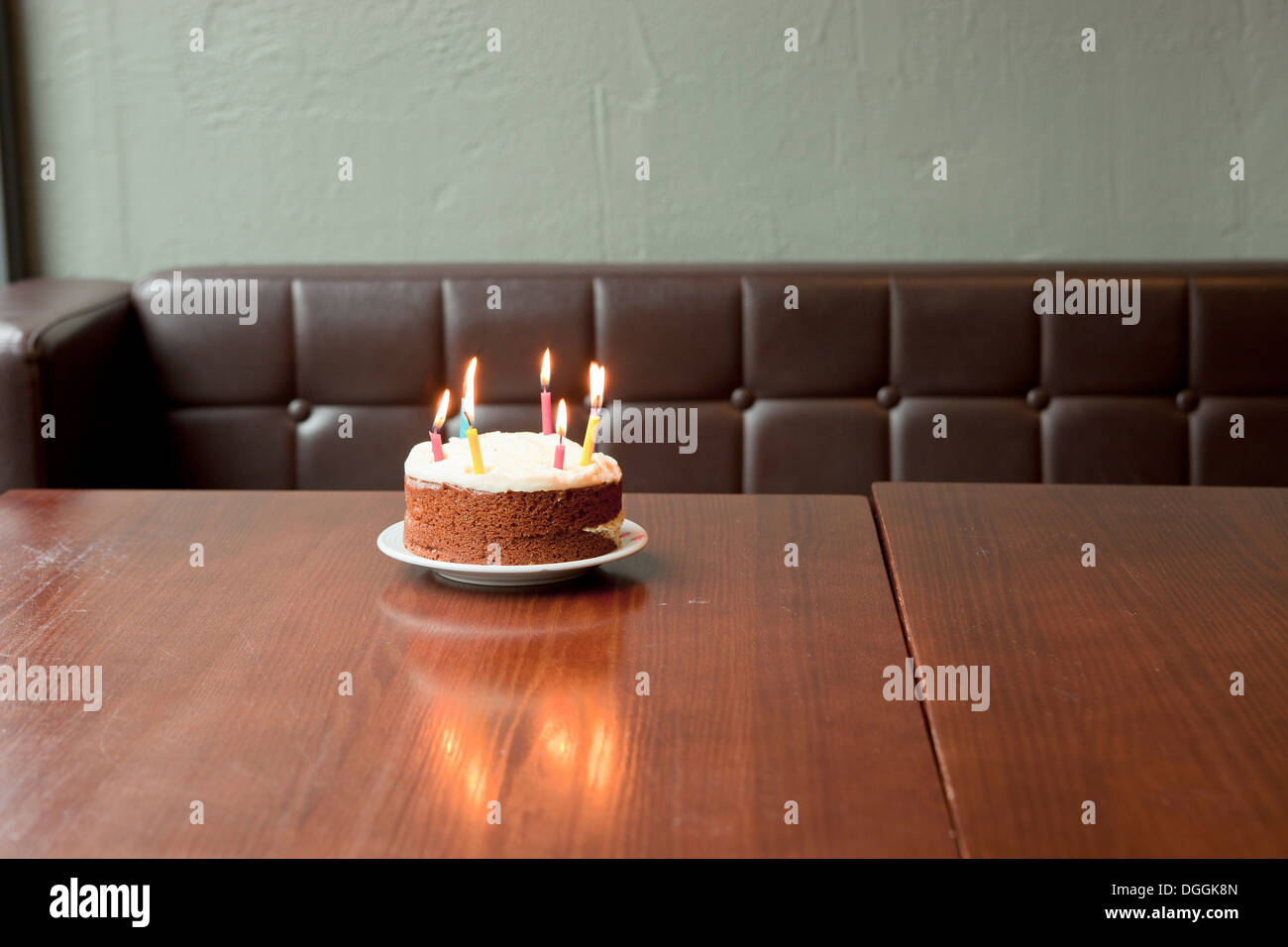 Birthday cake on table in restaurant Stock Photo - Alamy