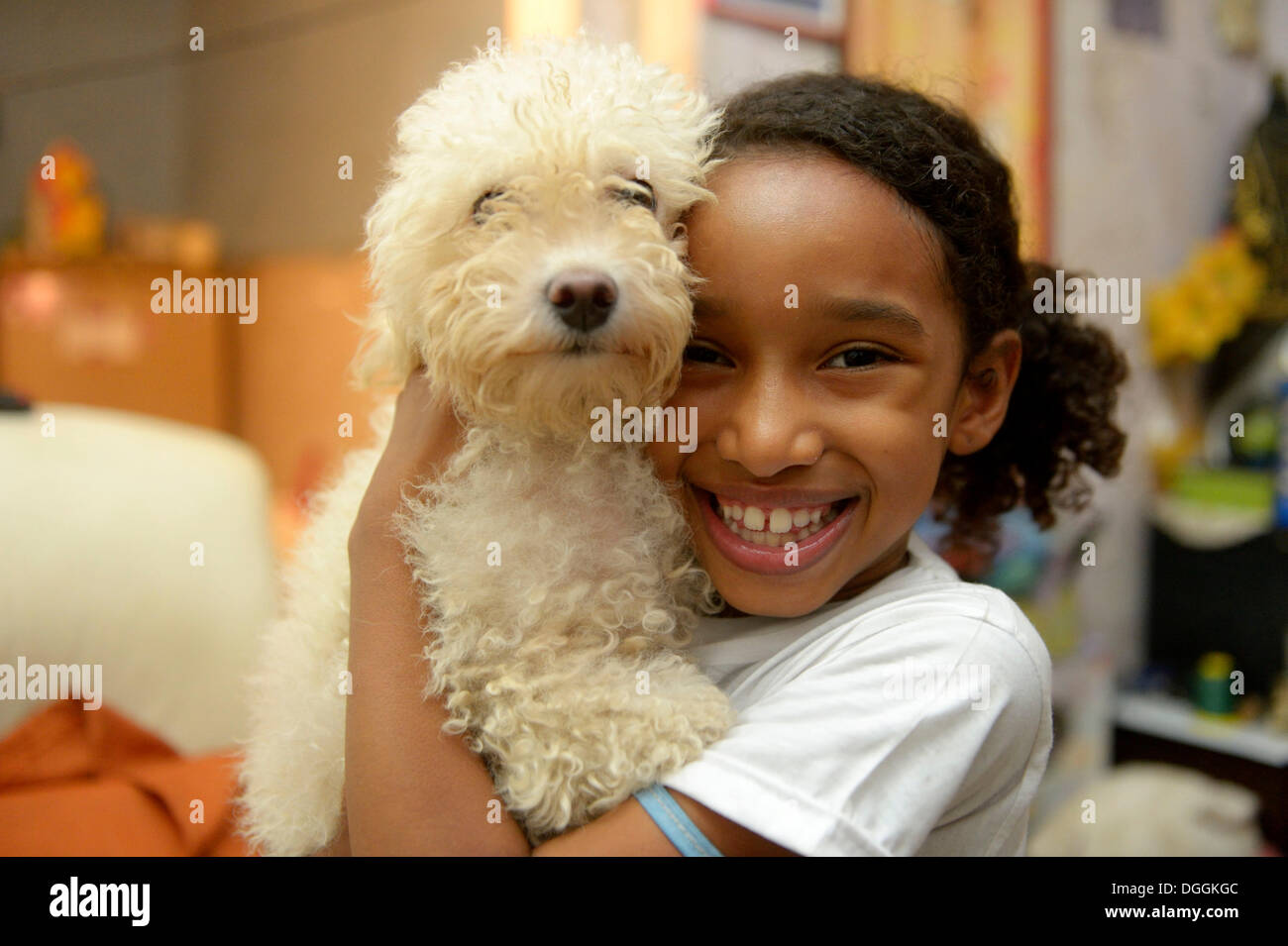 Girl with a poodle in a slum or favela, Jacarezinho favela, Rio de Janeiro, Rio de Janeiro State, Brazil Stock Photo