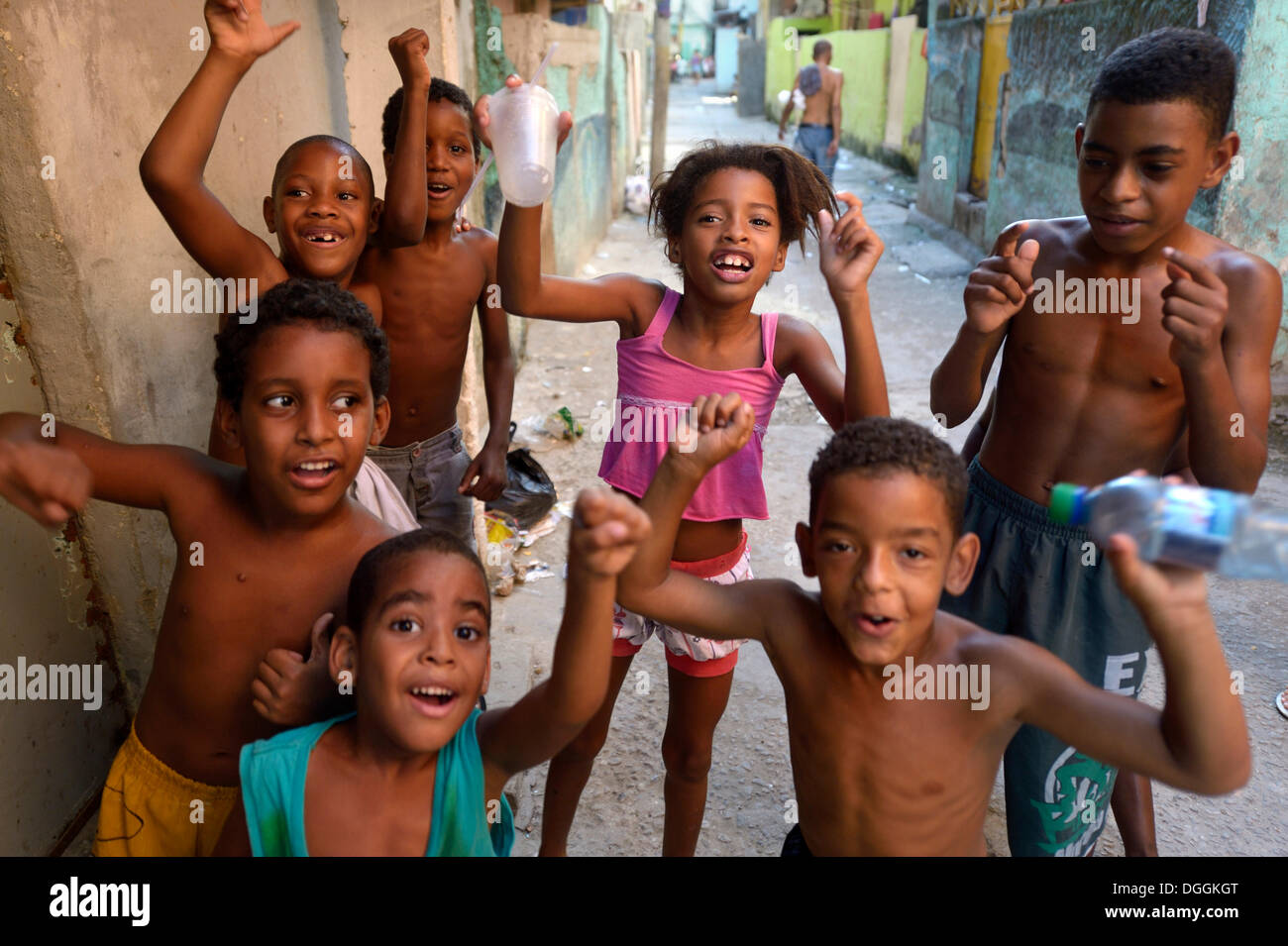 Children cheering happily in a slum or favela, Jacarezinho favela, Rio de Janeiro, Rio de Janeiro State, Brazil Stock Photo
