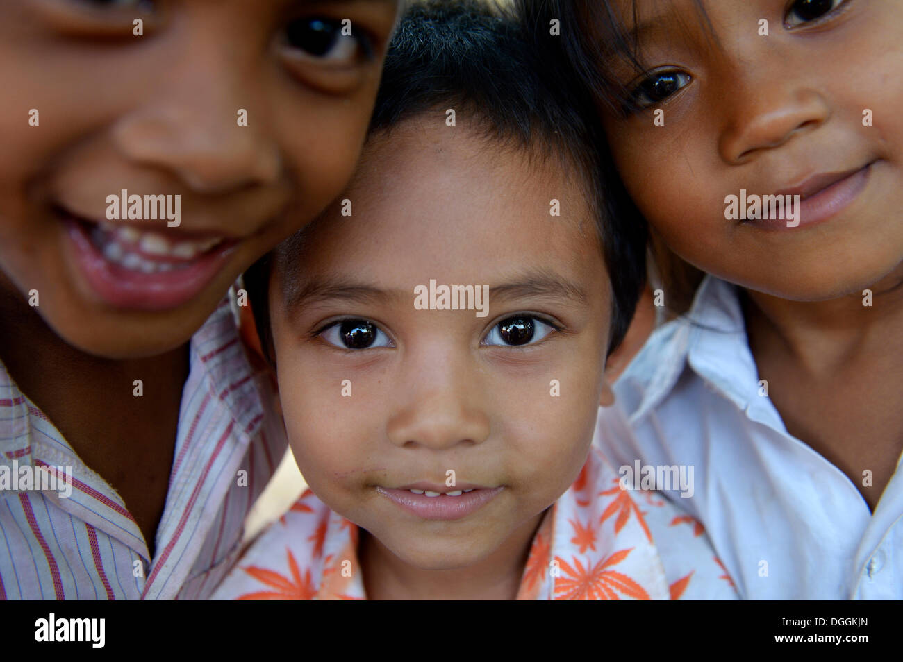 Two boys and a girl, standing close together, portrait, Lompong Village, Bathi District, Takéo Province, Cambodia Stock Photo