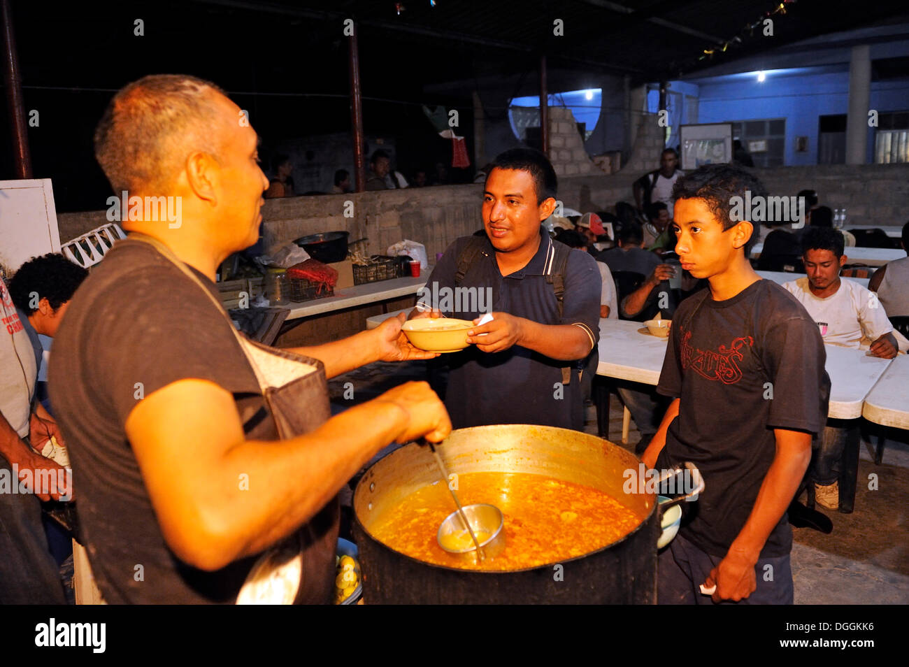 Migrants from Latin America crossing Mexico on their way to the U.S. receiving food in a Christian shelter, Ixtepec, Oaxaca Stock Photo