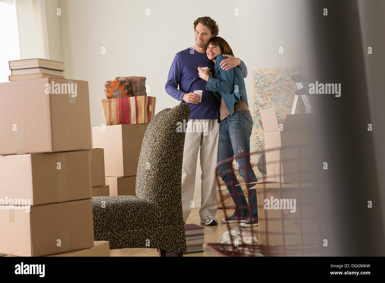 Couple having a drink break whilst moving Stock Photo