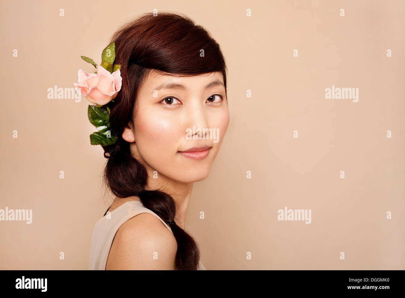 Mid adult woman wearing flower in hair, portrait Stock Photo Alamy