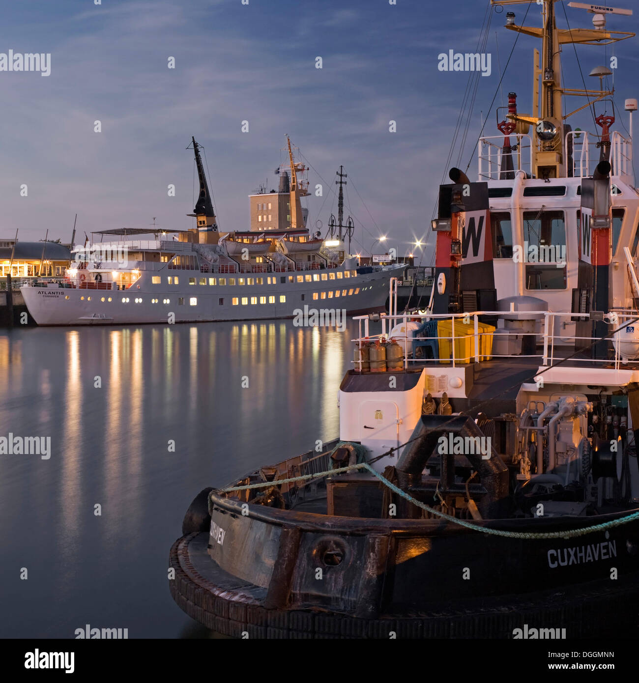 Cruise liner, Atlantis, and tugboat, Taucher O. Wulf 3, at Alte Liebe pier in Cuxhaven, Lower Saxony Stock Photo