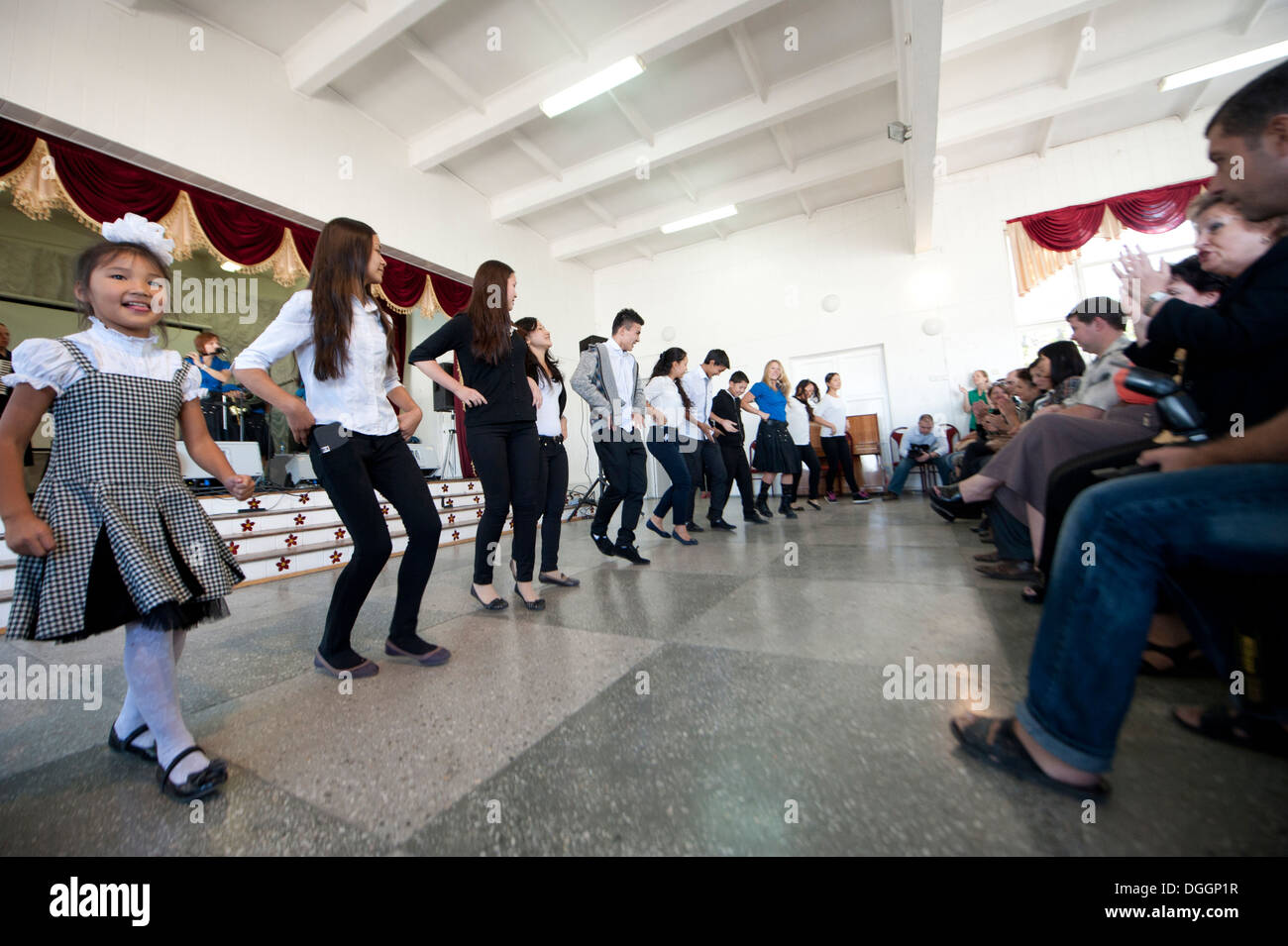 Students at Secondary School 26 in Bishkek, Krygyzstan, dance with members of the U.S. Air Forces Central Band the Blue Yonders Stock Photo