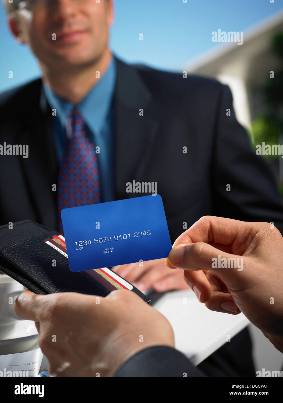 Man with wallet making credit card payment Stock Photo
