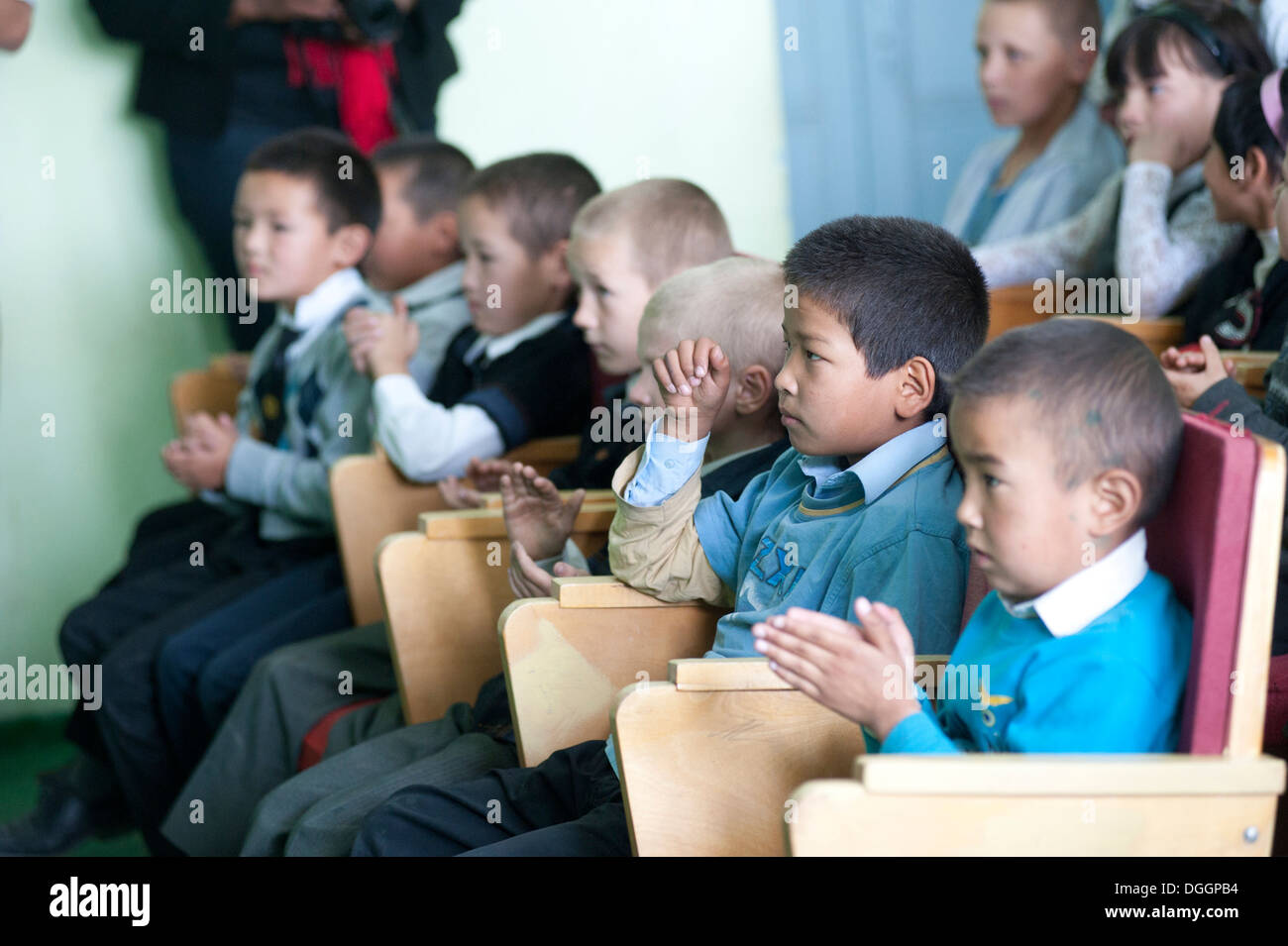 Children at Chui Orphanage-Boarding School clap during the U.S. Air Forces Central Band the Blue Yonders' performance in Bishkek, Kyrgyzstan, Oct. 4, 2013. The band toured through Transit Center at Manas, Kyrgyzstan, and the surrounding community. Stock Photo
