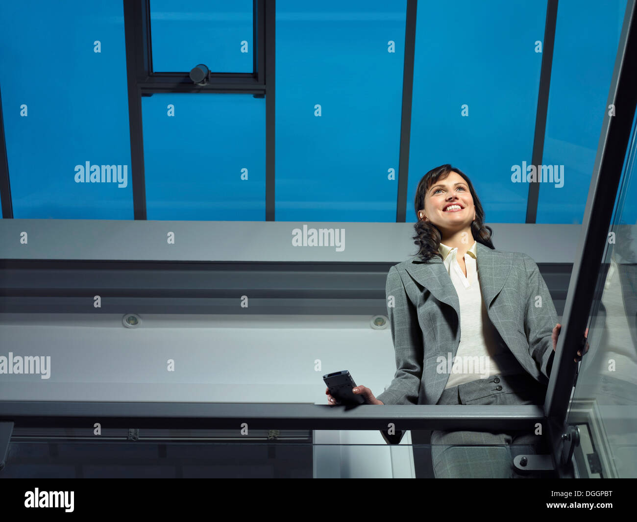 Smart lady in corporate environment with mobile phone Stock Photo - Alamy