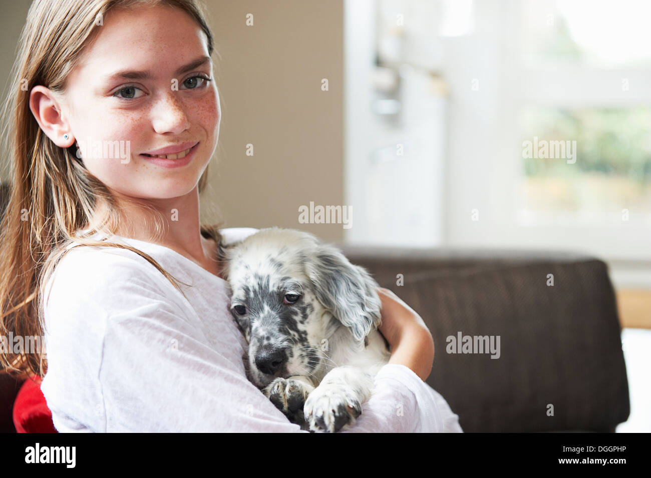 Teenage girl holding dog Stock Photo