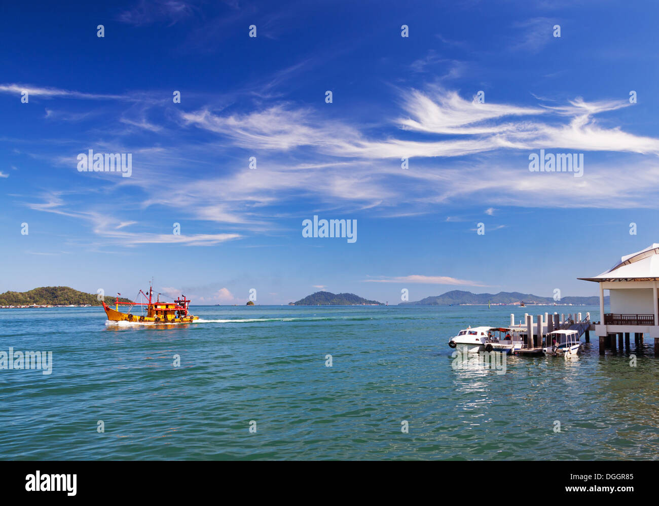 Seascape with boats and picturesque clouds. Borneo island, Malaysia. Stock Photo