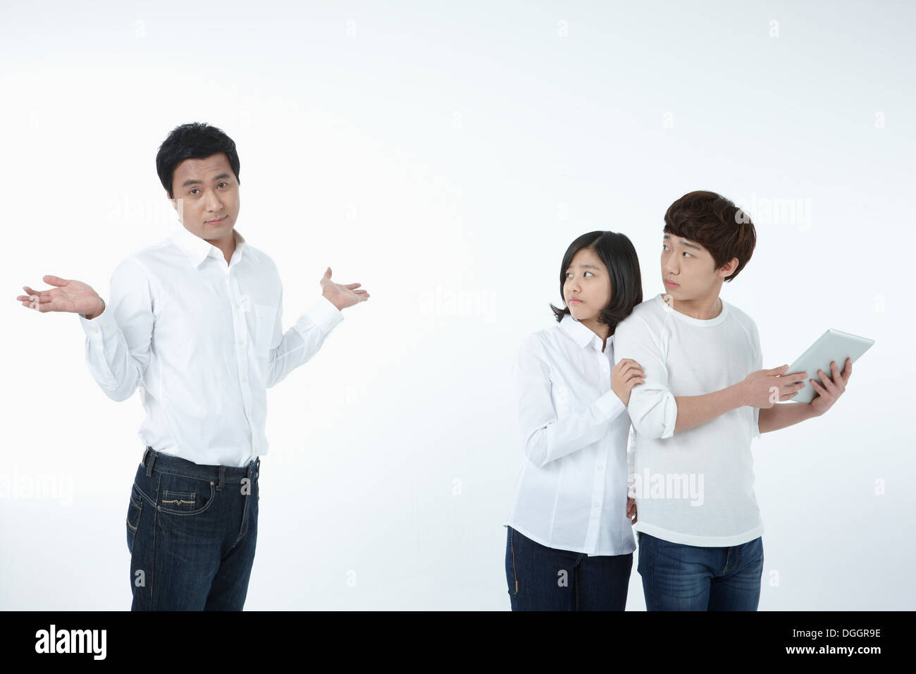 kids using tablet while father is looking Stock Photo