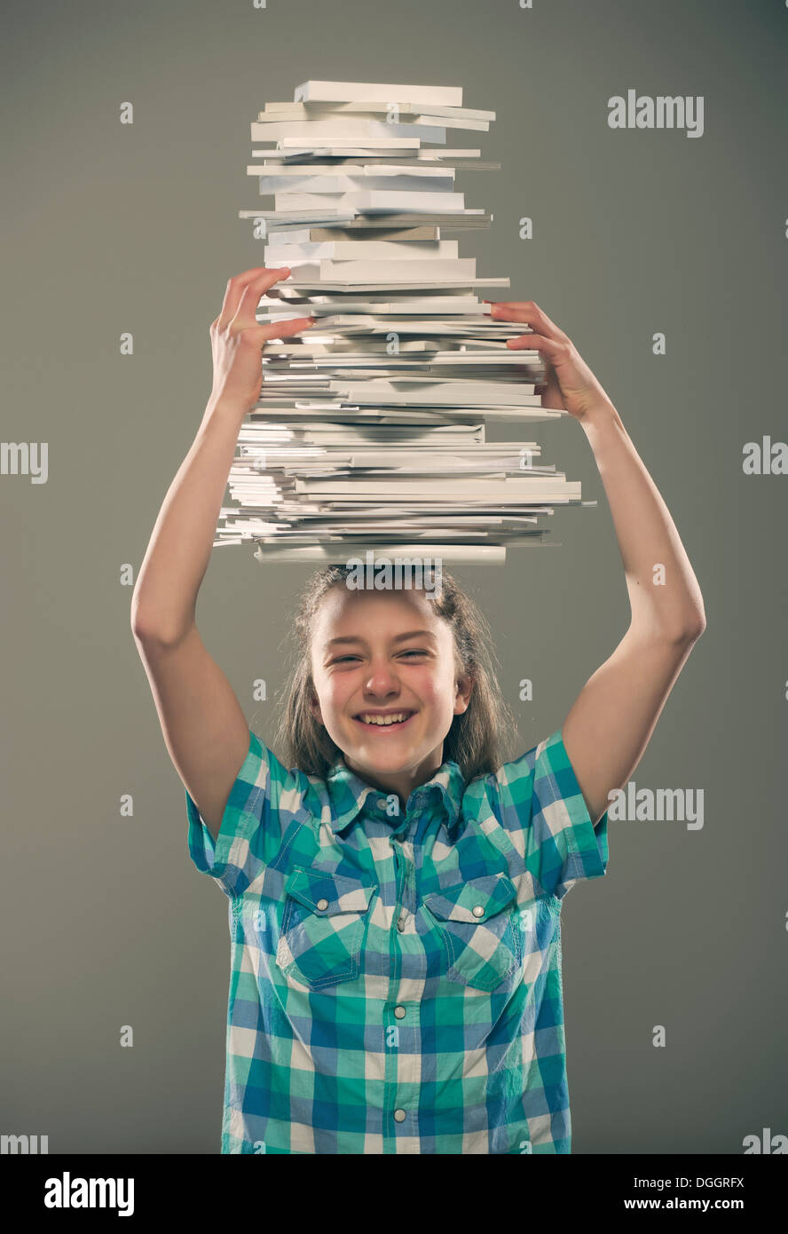 Girl carrying books on head Stock Photo