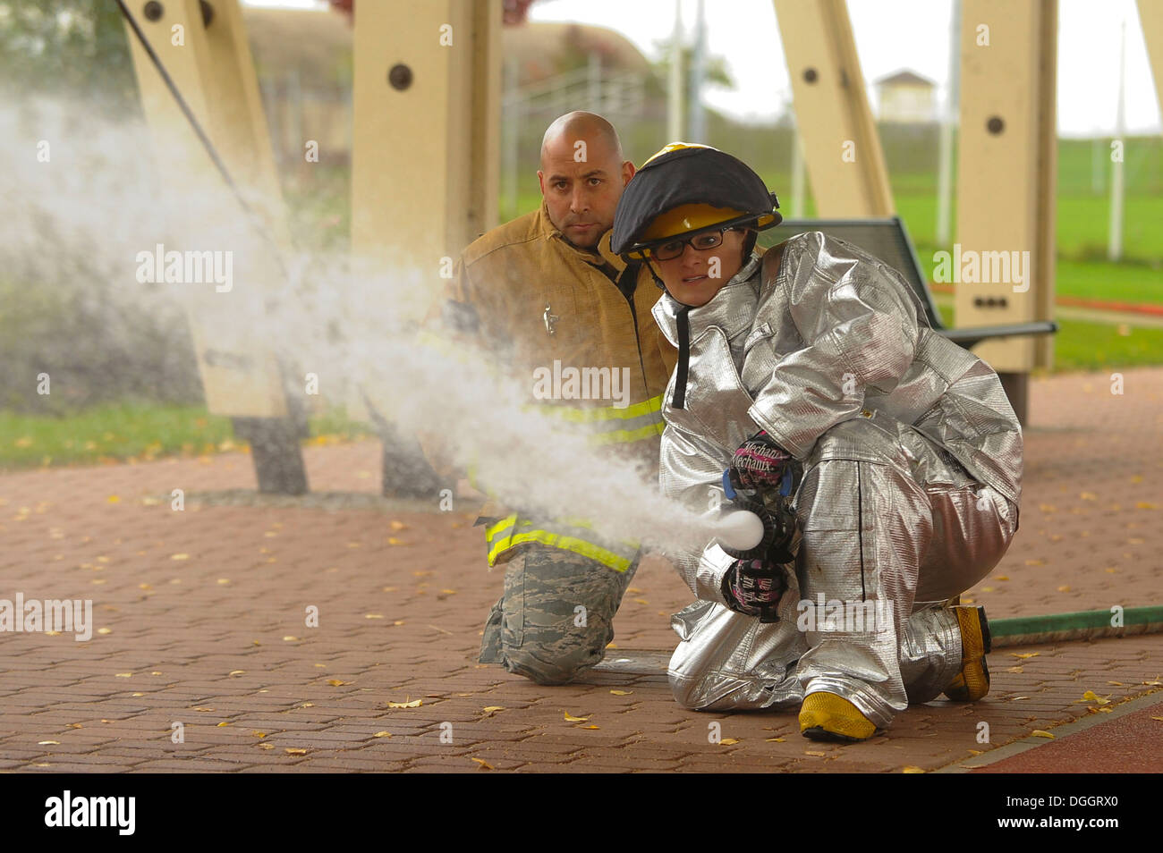 SPANGDHALEM AIR BASE, Germany--U.S. Air Force Senior Airman Katelyn Camacho, a 52nd Equipment Maintenance Squadron phase support member, from Corinth, Miss., uses a fire hose to knock over cones during the Fire Muster competition Oct. 10, 2013. The 52nd E Stock Photo