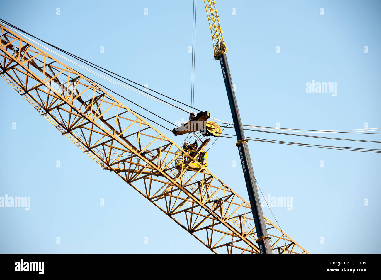 Large Crane being repaired by another crane Stock Photo