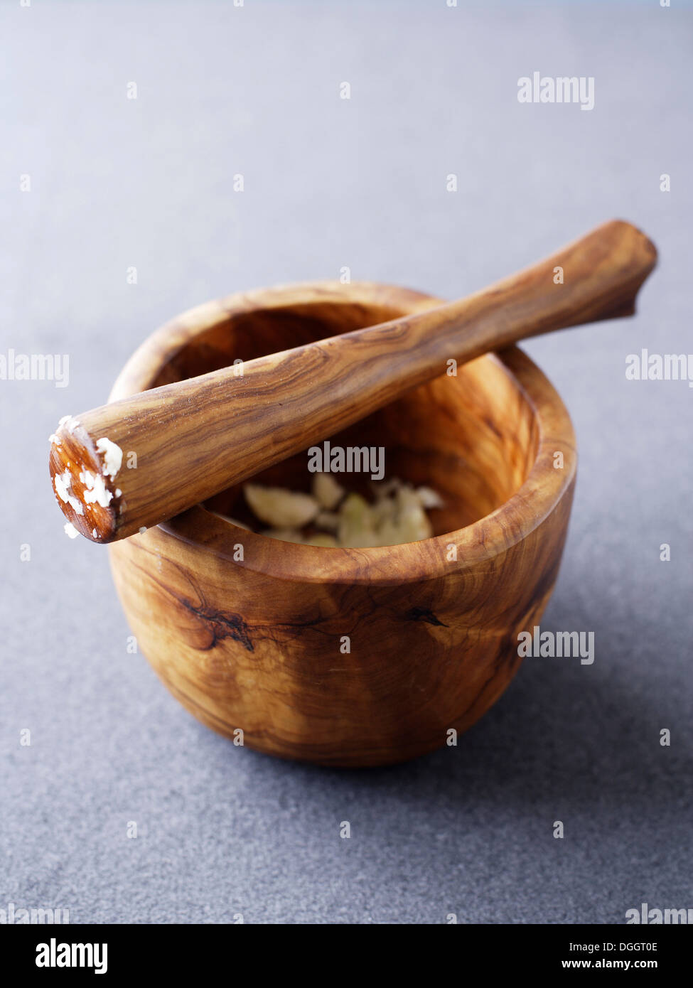 Wooden pestle and mortar with crushed garlic Stock Photo Alamy