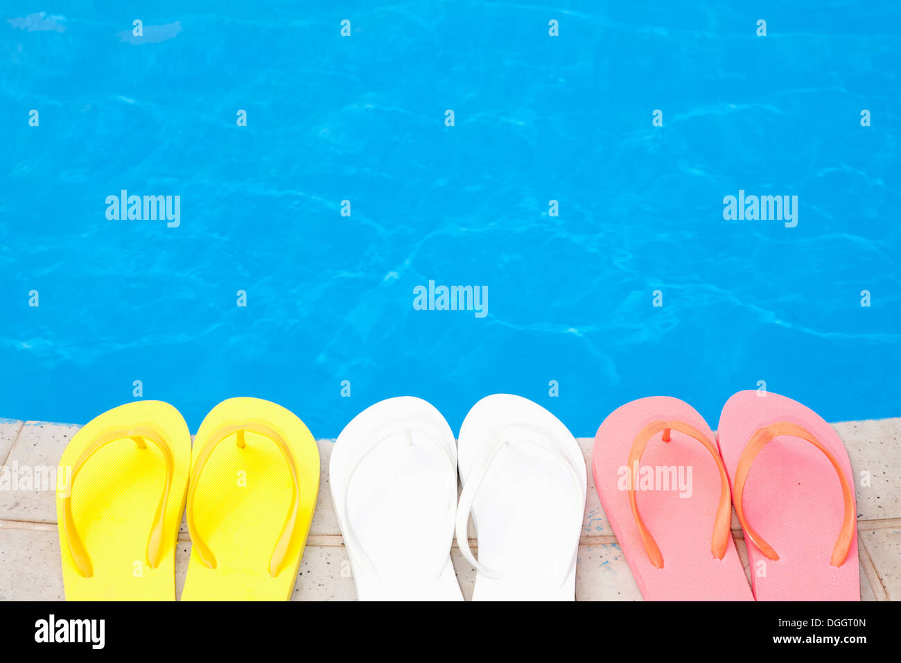 three pairs of flip flops next to a pool Stock Photo - Alamy