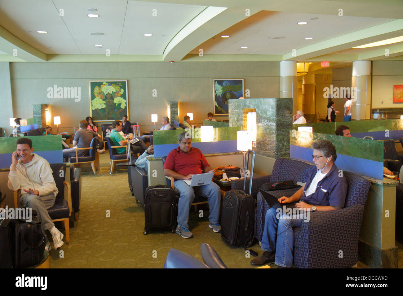 Miami Florida International Airport MIA,terminal,gate,American Airlines,Admiral Club,lounge,man men male,laptop,notebook,computer,sitting,looking FL13 Stock Photo