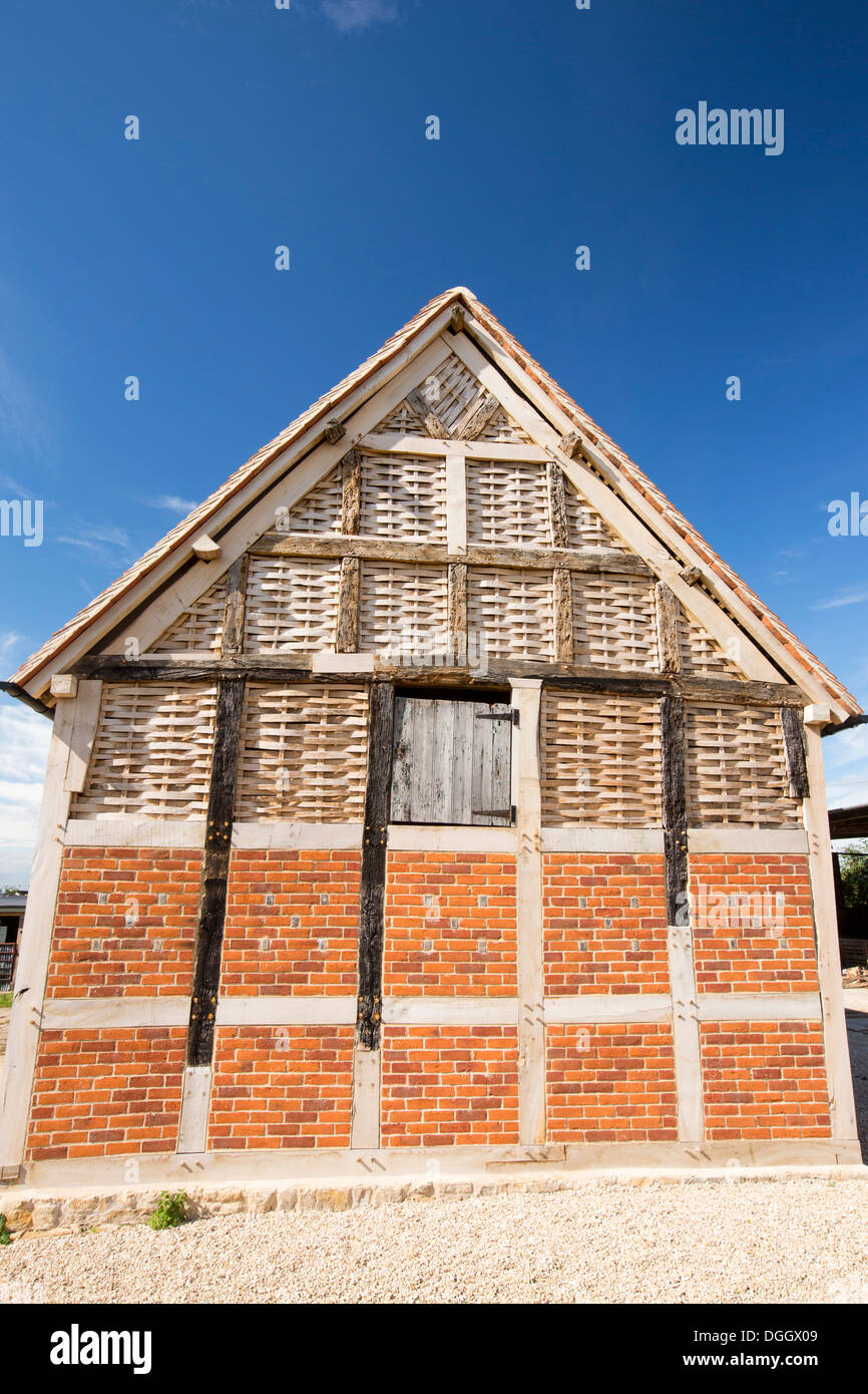 A fantastic old barn with upper walls woven from split timber on a farm