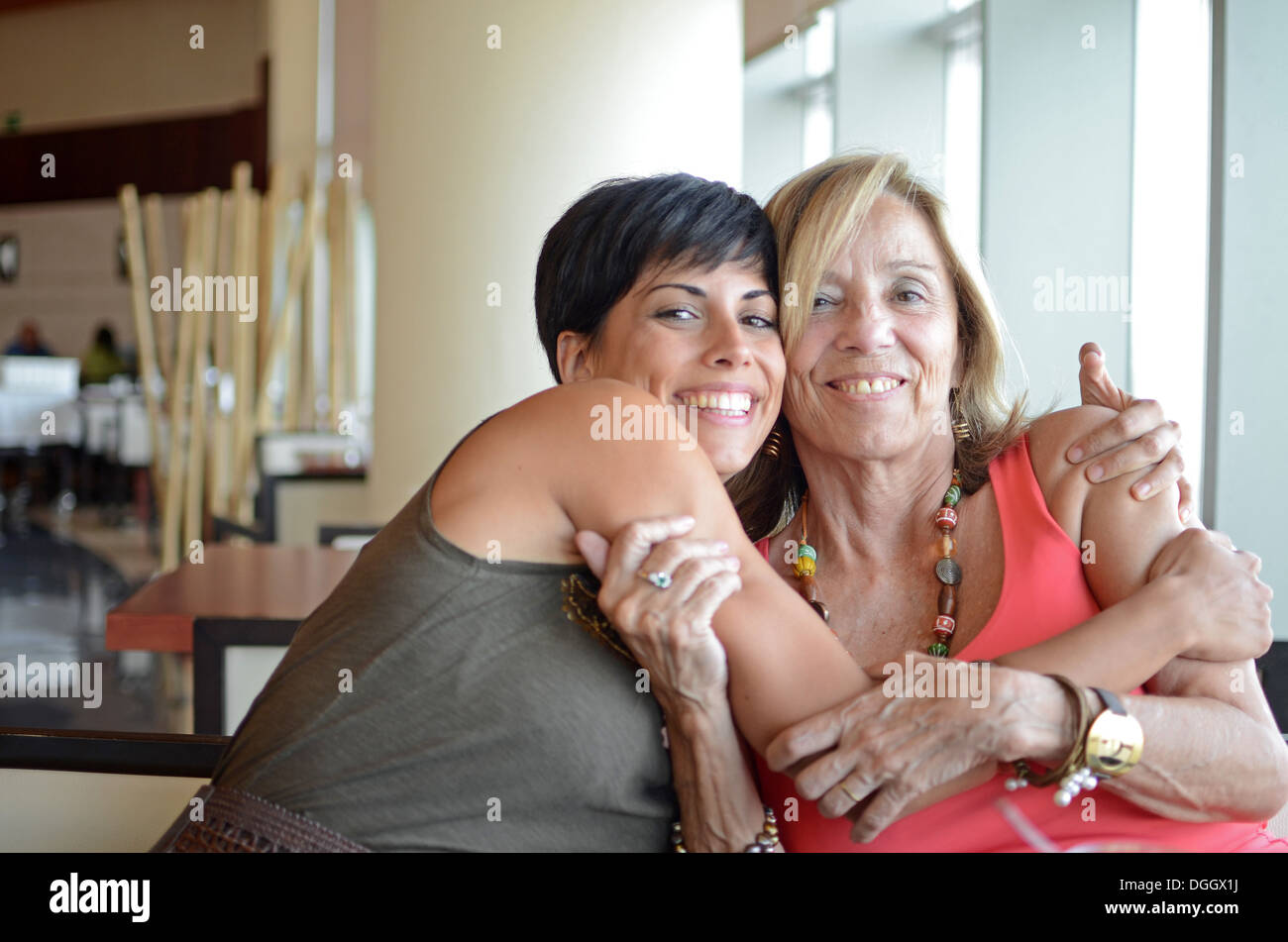 Mature and young woman hug affectionately Stock Photo - Alamy