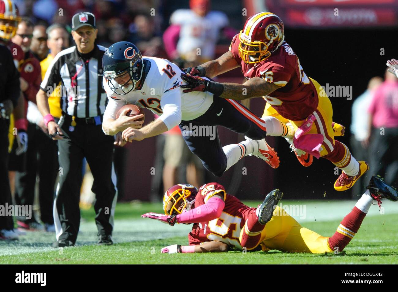 Landover, Maryland, USA. 21st Oct, 2013. OCT 20, 2013 : Chicago Bears quarterback Josh McCown (12) dives for the sideline as he gets hit by Washington Redskins inside linebacker Perry Riley (56) and Washington Redskins free safety David Amerson (39) during the matchup between the Chicago Bears and the Washington Redskins at FedEx Field in Landover, MD. © csm/Alamy Live News Stock Photo