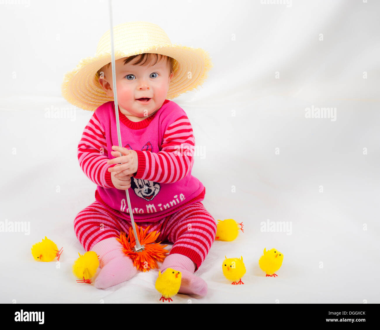 baby girl in cute pose wearing straw hat Stock Photo